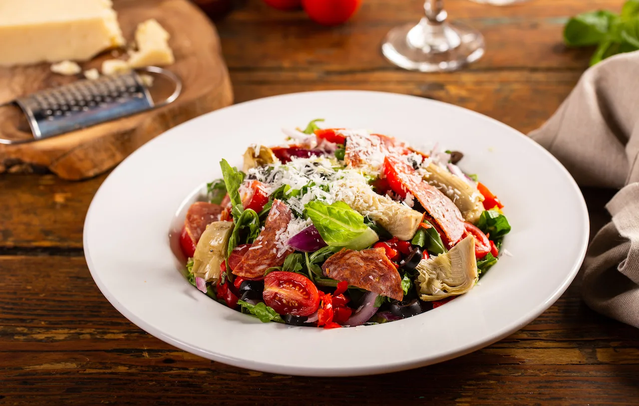 Italian antipasto salad with salami, artichoke hearts and olives Italian antipasto salad with salami, artichoke hearts and olives