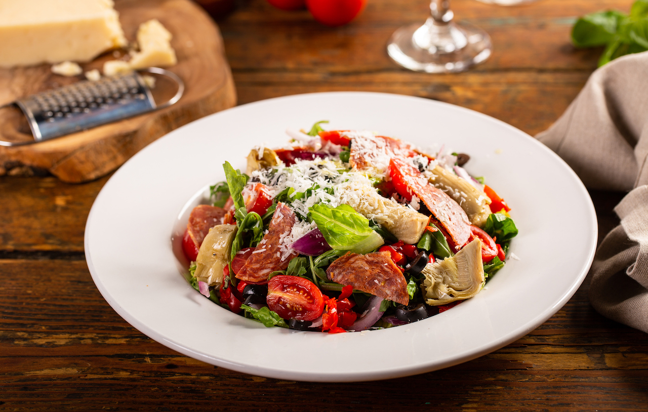 Italian antipasto salad with salami, artichoke hearts and olives Italian antipasto salad with salami, artichoke hearts and olives