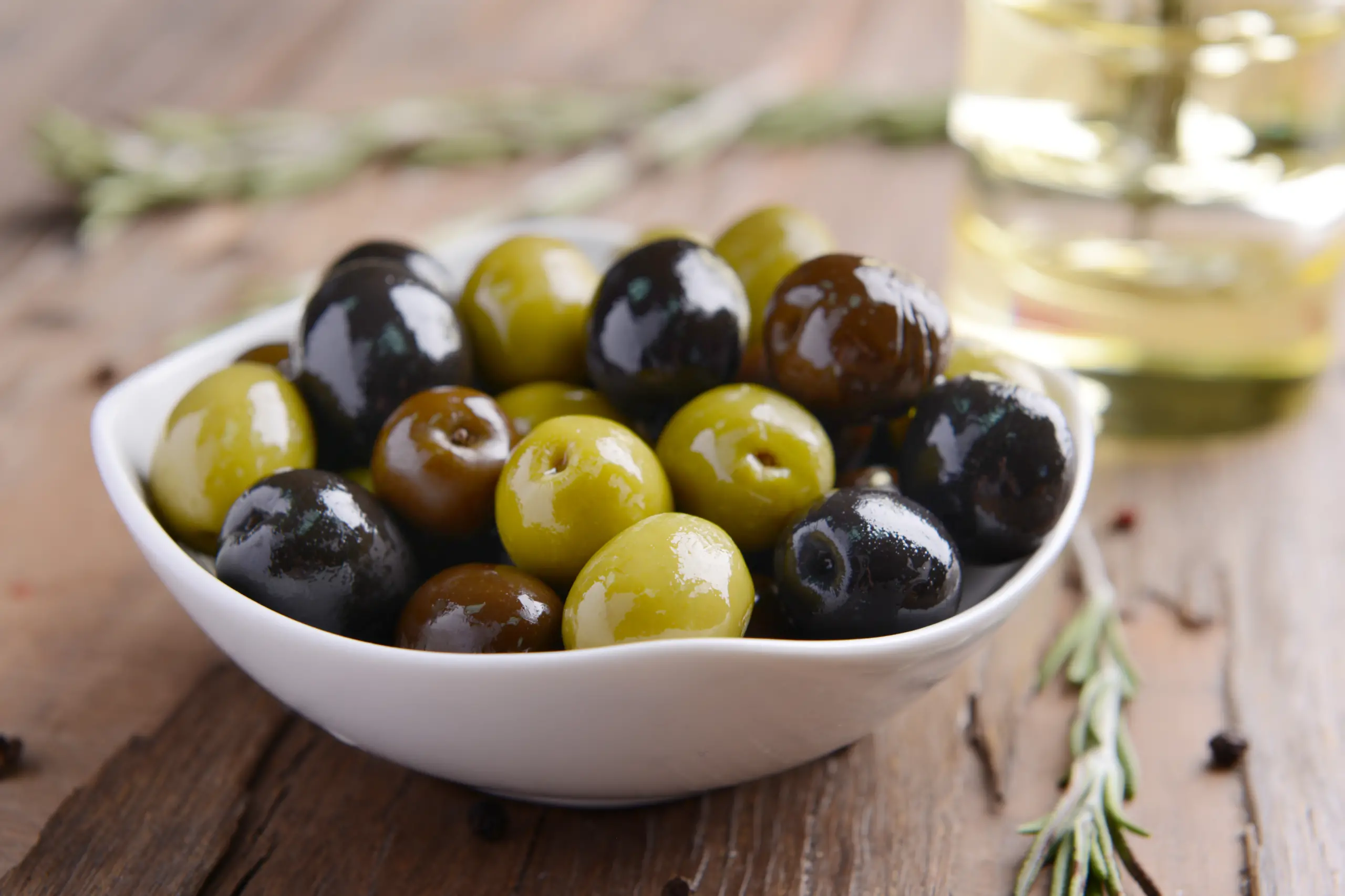 Different Marinated Olives On Table Close Up