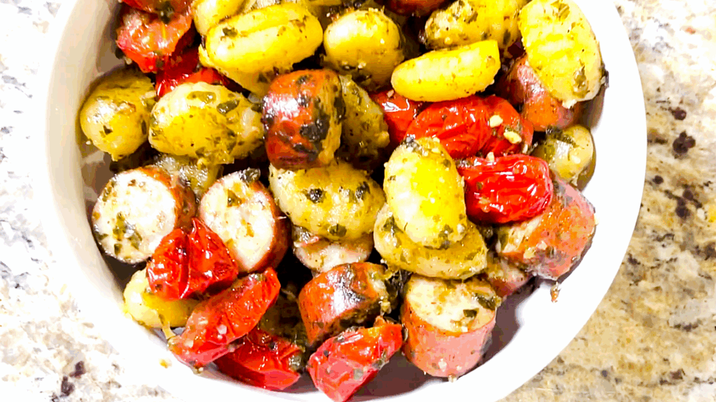Nick Tenuta's Sheet Pan Gnocchi with Italian Sausage, Roasted Tomato, and Pesto